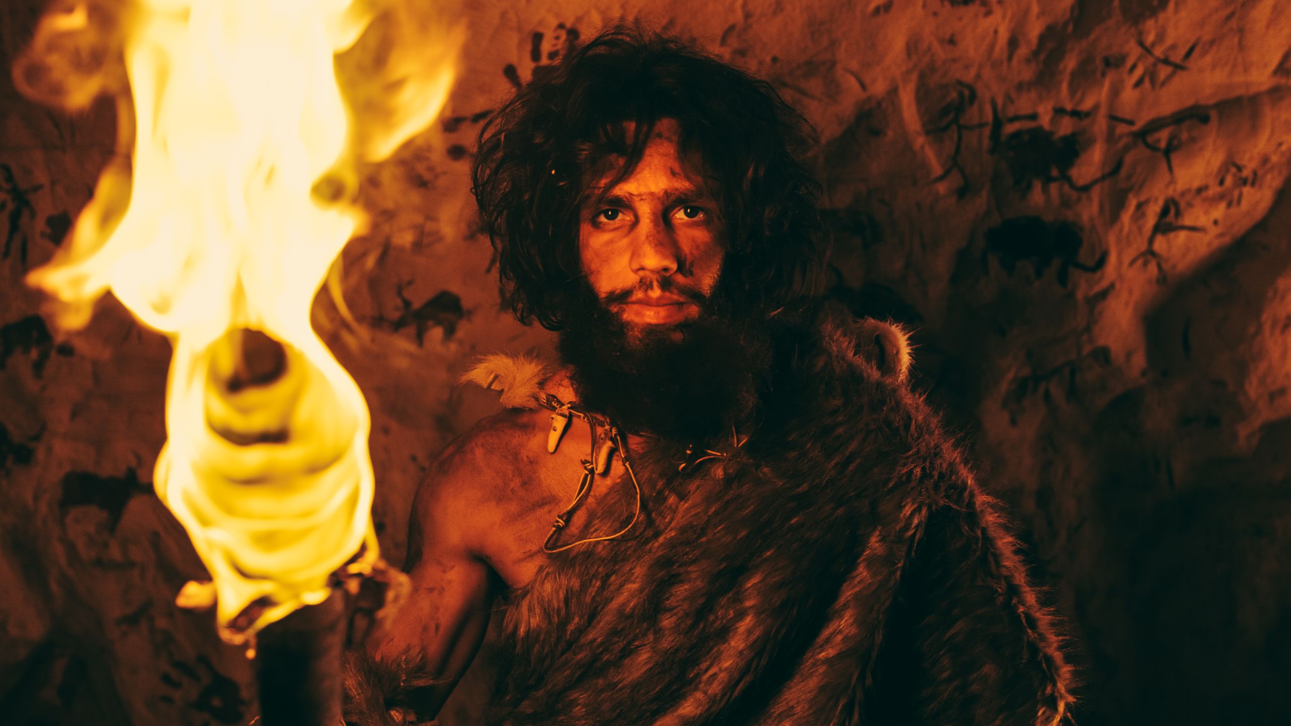 Portrait,Of,Primeval,Caveman,Wearing,Animal,Skin,Standing,In,His